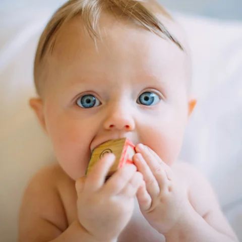 Baby exploring a toy during an everyday milestone