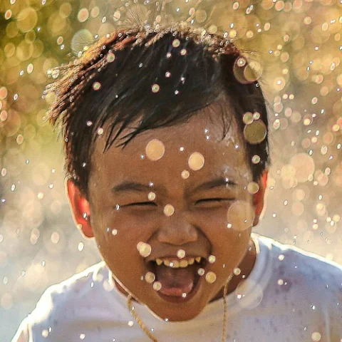 Child laughing during playful outdoor progress
