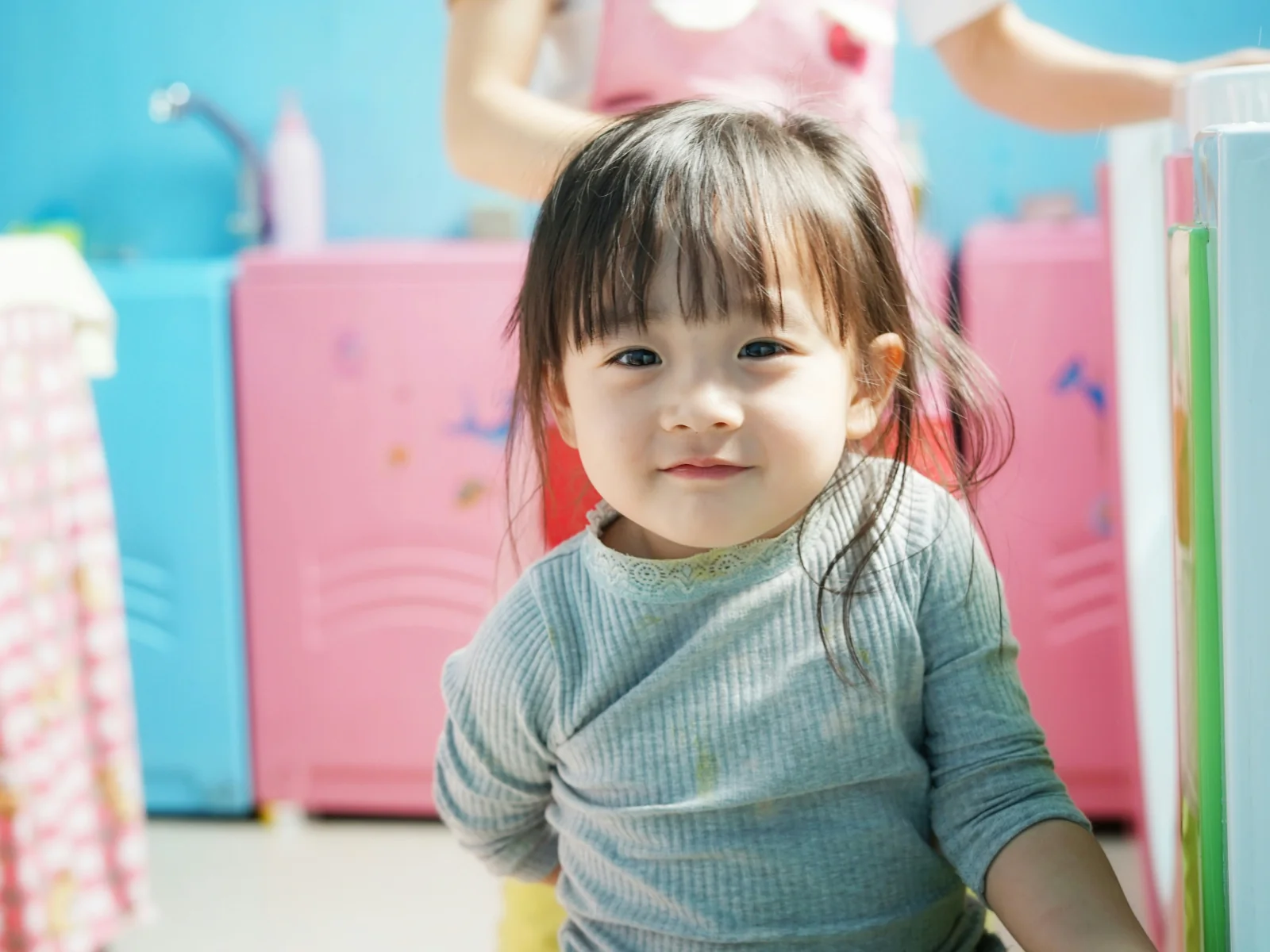Smiling toddler during potty training in a colorful bathroom