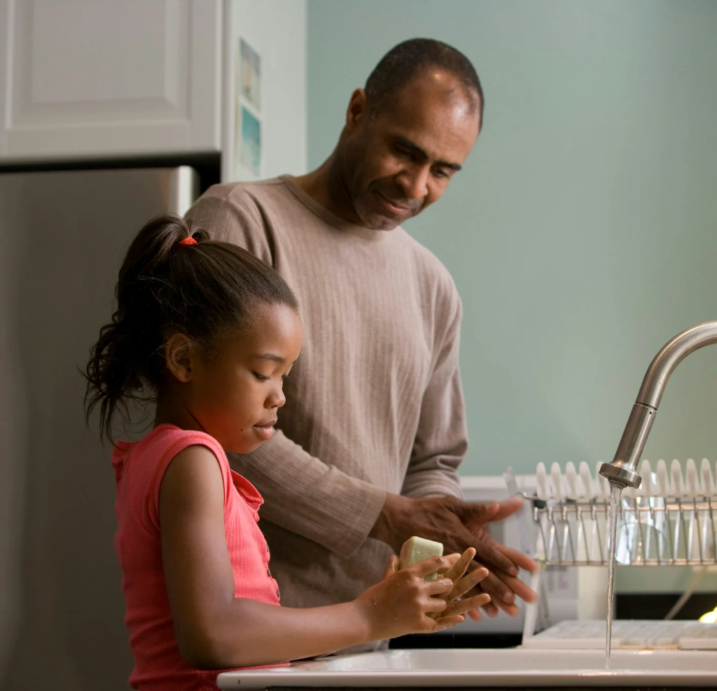 Parent helping a child wash hands as part of a calm routine